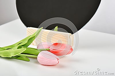 Tulip flowers bouquet for celebration with mirror. Artificial tulips on white table, Gift for special day Stock Photo