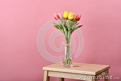 Tulip flowers bouquet for celebration on pink background. Artificial tulips arrangement Stock Photo