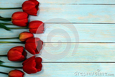 Red tulips on a wooden background with a place for inscription Stock Photo