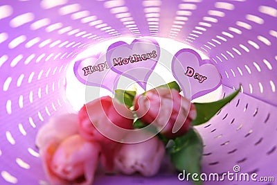 Tulips and paper hearts with written words HAPPY MOTHER'S DAY wrapped in color paper Stock Photo