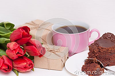 Tulips, presents, cake, cup for mother, wife, daughter, girl. Happy birthday, Mother`s day. Woman`s day Stock Photo