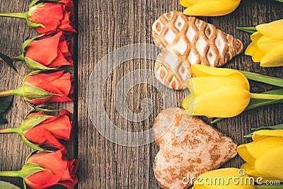 Tulips and roses arranged on decks. View from above. Free space. Stock Photo