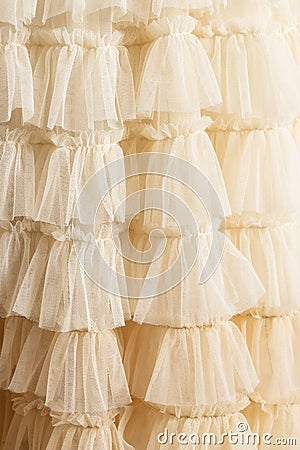 Tulle beige luxury dress with ruffles. Stock Photo