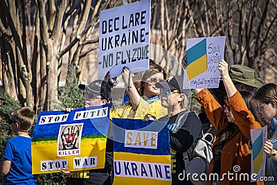 Support Ukraine Rally with many signs in blue and yellow - Putins Face with Killer - Save Ukraine - No Fly Editorial Stock Photo