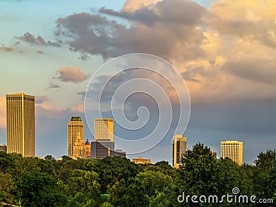 Tulsa skyline from the Northwest over trees and under and beautiful sunset sky Stock Photo