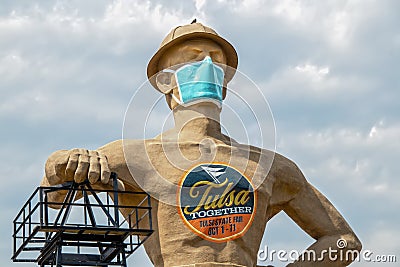 Iconic Golden Driller - Giant statue near Route 66 in Oklahoma wearing facial mask during pandemic Editorial Stock Photo