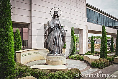 Tulsa USA - Mary Queen of Heaven Statue on round pedestal in front of St. Francis Hospital in seating area near Editorial Stock Photo