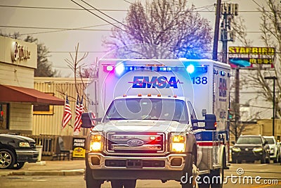2-1-2019 Tulsa USA - Oncoming EMSA ambulance with lights blazing on urban street on overcast day - selective focus Editorial Stock Photo