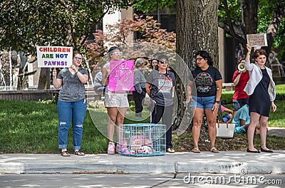 7-2-2019 Tulsa USA -Protesters at park with signs and dolls in a cage-Children are not pawns - is this what it means to be pro- Editorial Stock Photo