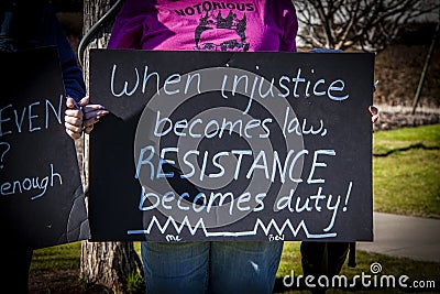 Tulsa USA Woman in pink Notorious RBG teeshirt holds handmade sigen - When injustice becomes law RESISTANCE becomes Editorial Stock Photo
