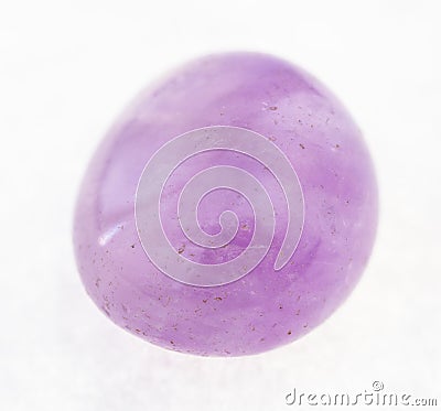 tumbled Amethyst (violet quartz) gem on white Stock Photo