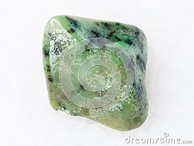 tumbled green Grossular garnet gemstone on white Stock Photo