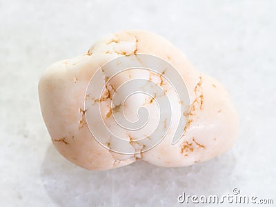 tumbled magnesite stone on white marble Stock Photo