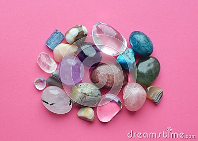 Tumbled and rough gemstones and crystals of various colors. Amethyst, rose quartz, agate, apatite, aventurine, olivine, turquoise Stock Photo