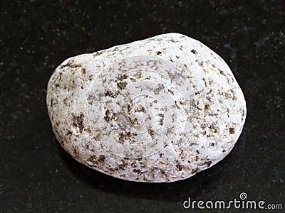 Tumbled of white Granite stone on dark background Stock Photo