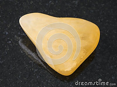 tumbled yellow Aventurine gem stone on dark Stock Photo