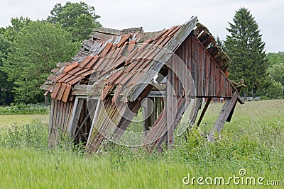 Tumbledown barn on a field Stock Photo