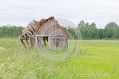 Tumbledown barn on a field Stock Photo