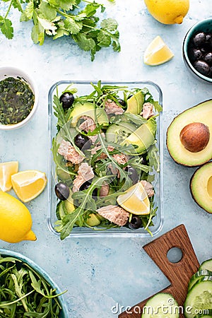 Tuna arugula salad prepared ahead and packed in a glass lunch box Stock Photo