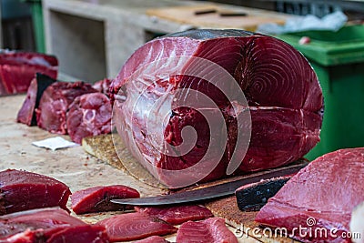 A tuna being cleaned and cut at a fish market. Stock Photo