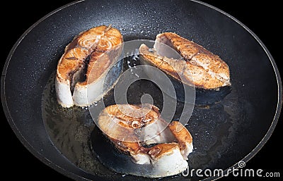 Tuna fish with spices fried on black pan Stock Photo