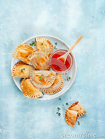 Tuna patty with tomato and pepper, typical Spanish empanadas with sauce on light surface with copy space Stock Photo