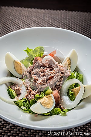 Tuna salad with eggs, tomatoes, salad leaves and onions Stock Photo