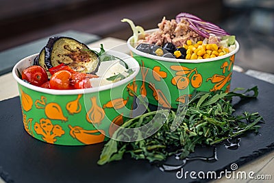 Tuna salad fresh vegetables menu fast food take&Go black table plate Stock Photo