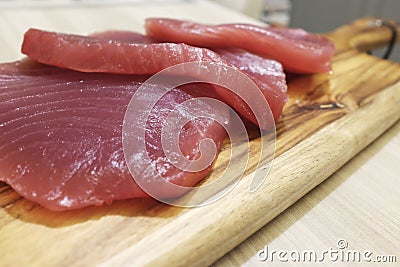 Tuna steak on a wooden board, tasty fish dinner Stock Photo