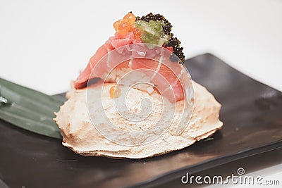 Tuna sushi with roe on top served on crab carapace Stock Photo