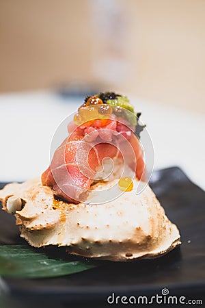 Tuna sushi with roe on top served on crab carapace Stock Photo