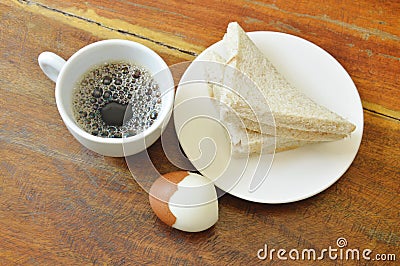 Tuna whole wheat sandwich on plate and boiled egg eat couple with black coffee cup Stock Photo