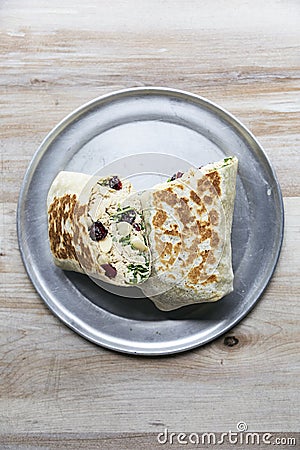 Tuna wrap with arugula, avocado, dried cranberries and shaved almonds Stock Photo