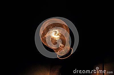 Tungsten bulb yellow filament with shadow Stock Photo