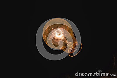 Tungsten bulb yellow filament with shadow Stock Photo