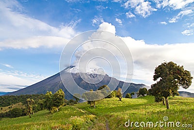 Tungurahua Volcano erupting at sunrise with smoke Stock Photo