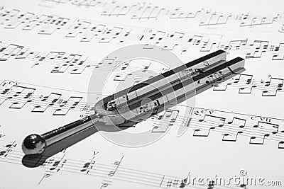 Tuning fork on sheet music Stock Photo