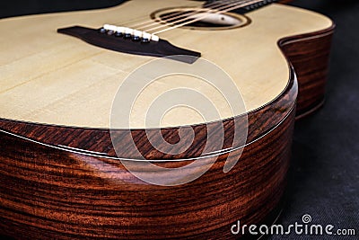 Tuning pegs on wooden machine head of six strings acoustic guitar neck on black background Stock Photo