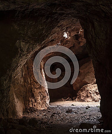 Tunnel in big rock cave Stock Photo