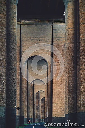 Tunnel or a passage with a series of tall arches and bike lane in NYC Stock Photo