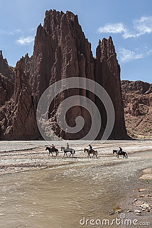 Unidentified men riding horses in the beautiful Quebrada Seca y El Duende Canyon, near Tupiza - Bolivia, South America Editorial Stock Photo