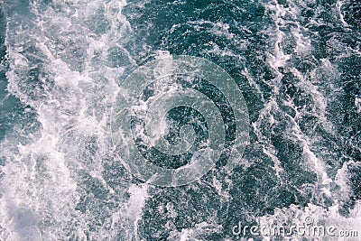 Turbulence made by foam of sea water from a high-speed yacht on surface of sea. Blue sea waves with lot of sea foam. Surface of Stock Photo