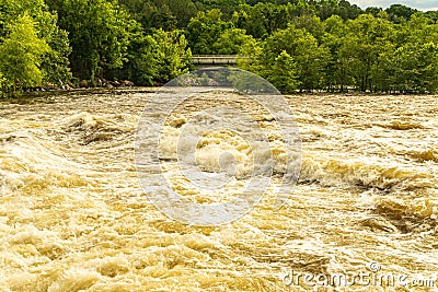 A Turbulent River with Whitecaps and Whirlpools after Spring Rain. Stock Photo