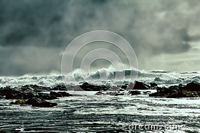 waves of Pacific ocean and rugged beauty of basalt rocks Stock Photo