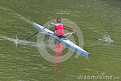 Turin, Italy May 9, 2014 athletic woman enjoy outdoors sports, she is rowing in the Po Editorial Stock Photo