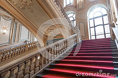 Turin, Italy - Palazzo Barolo staircase. Luxury palace with old baroque interior and red carpet Editorial Stock Photo