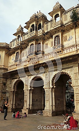 Turist photographing locals at Gangaur Ghat, the city centre`s main access point to Lake Pichola Udaipur Editorial Stock Photo