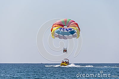 Extreme entertainment, tourists on a parachute climb on a rope from a boat Editorial Stock Photo