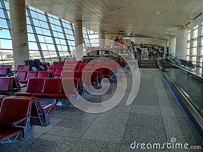 Large bright hall with many red seats in the departure area of Ankara Esenboga Airport ESB. Editorial Stock Photo