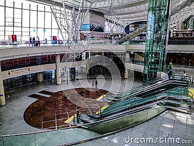 Large light hall with escalator and glass elevator at Ankara Esenboga Airport ESB. Interior Editorial Stock Photo